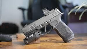 Close-up image of the SIG SAUER P365 X-Macro 9mm handgun featuring optics-ready slide, integrated compensator cuts, XRay3 night sights, and 17-round extended magazine